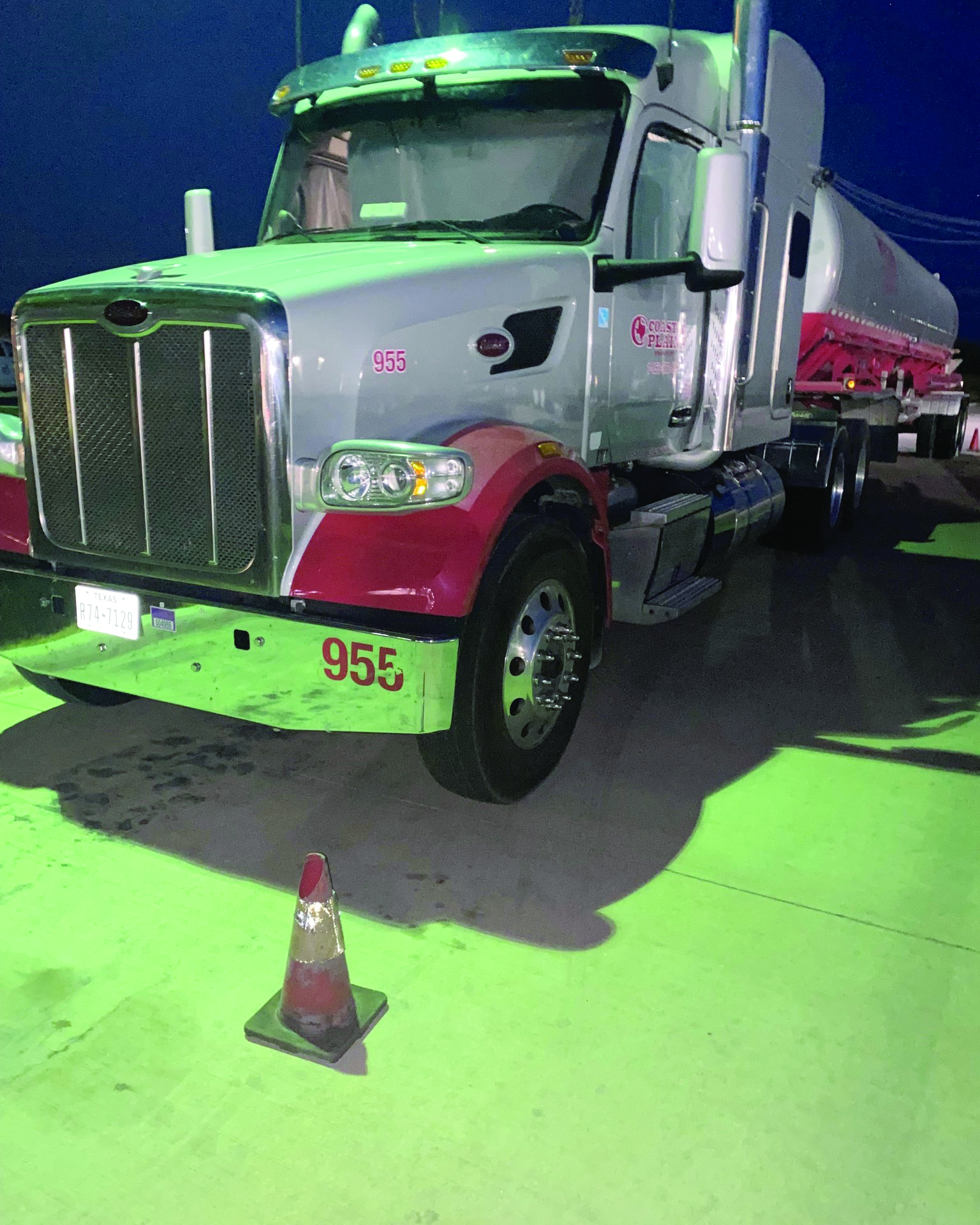 Bill Wallace, a professional truck driver for Coastal Plains Trucking, displays professionalism with parked truck's safety features.
