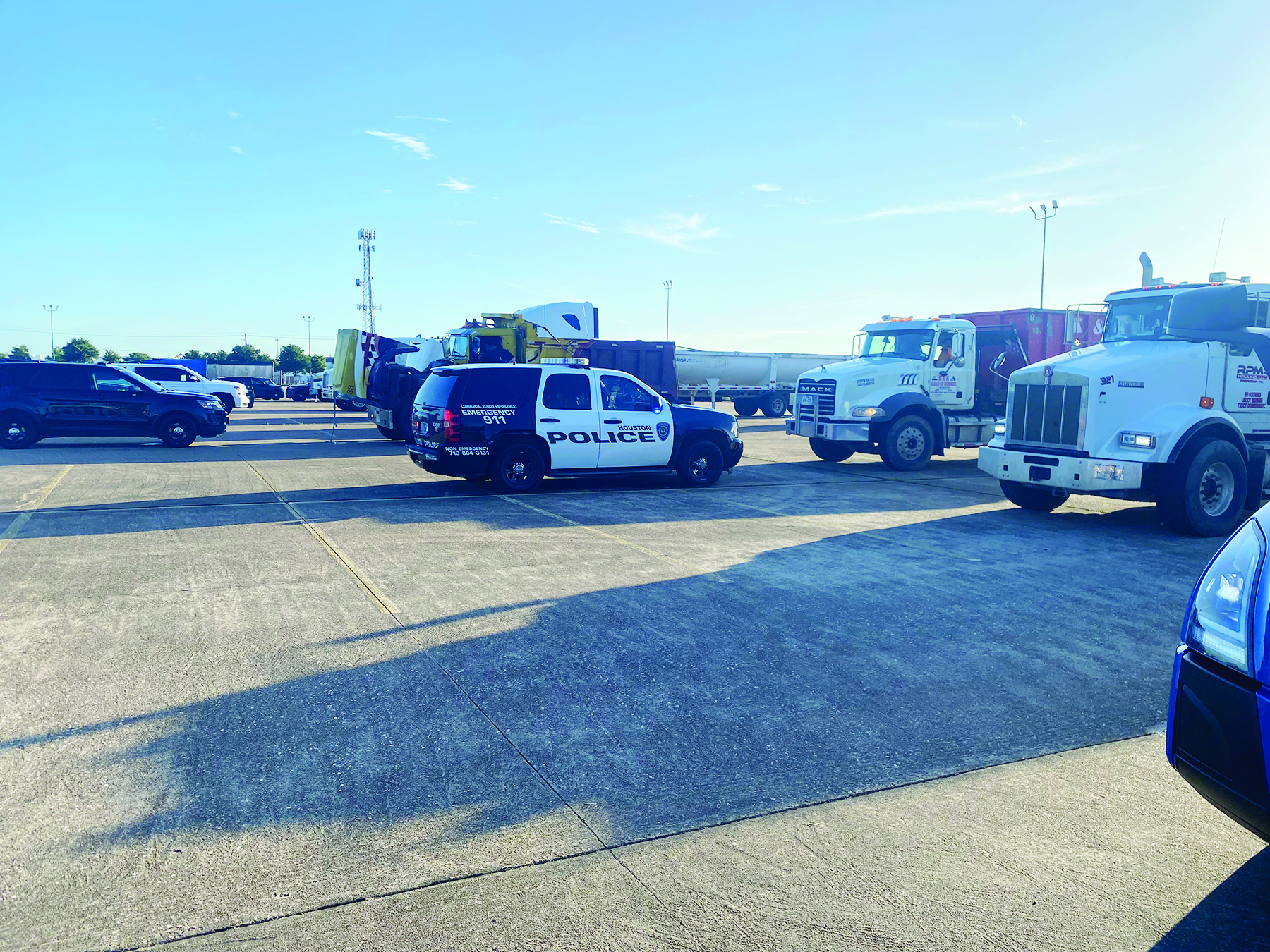 Parking lot filled with law enforcement agencies performing live inspections is featured.