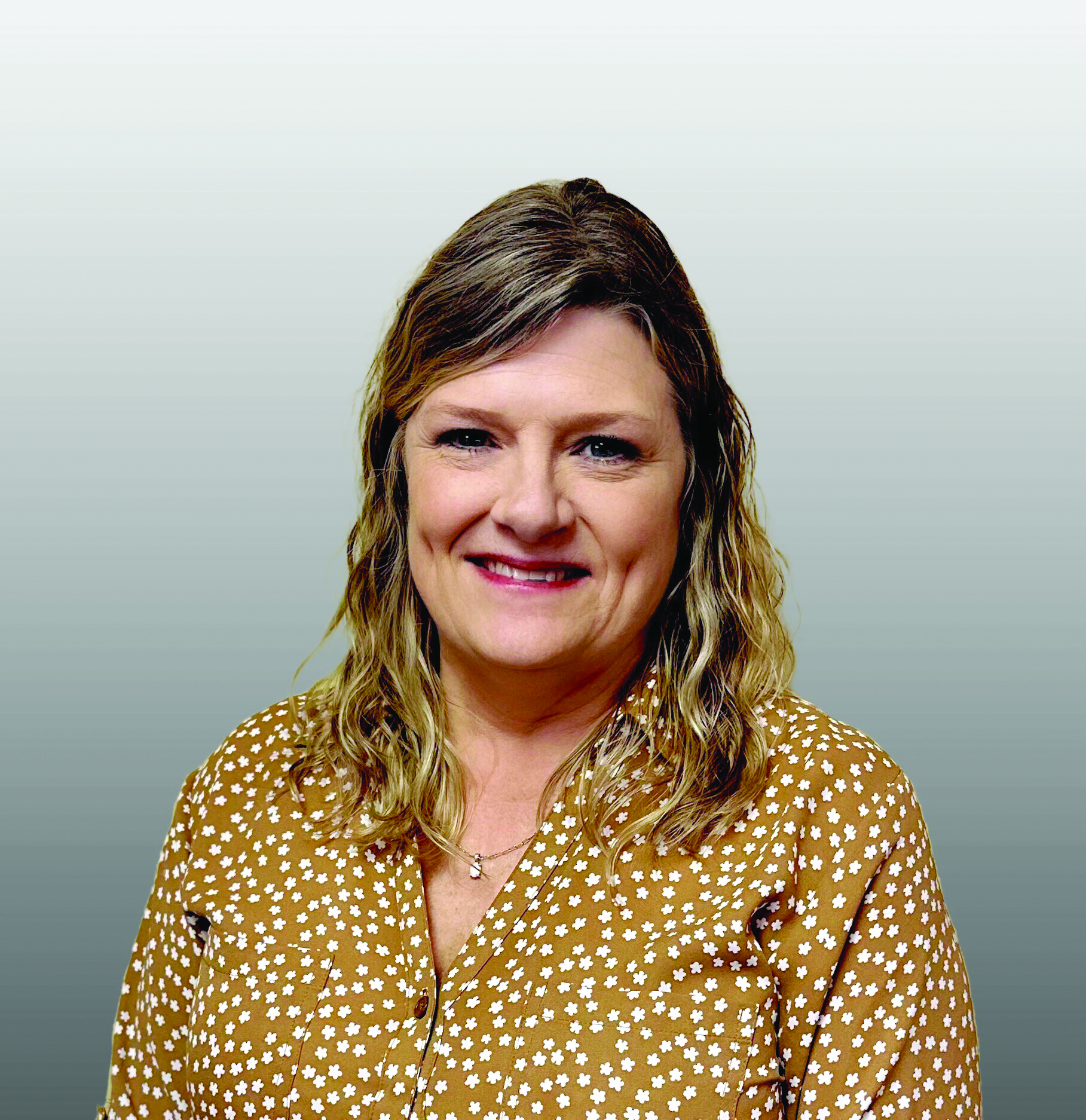 Julie Brazil smiles to camera as she celebrates new role with Coastal Plains Trucking.