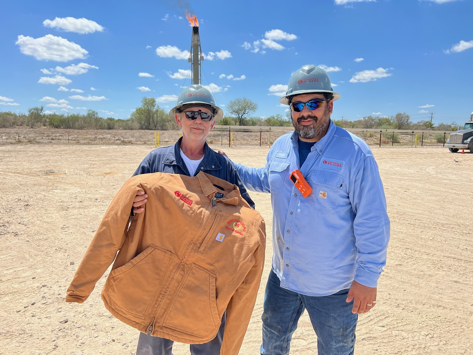 Tyler Nalley receives a Carhart jacket is thank you for his 12 years of service to Coastal Plains Trucking.
